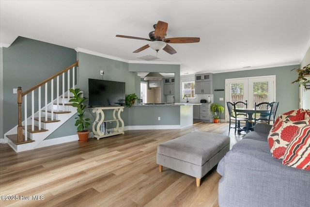8 Saunders Ln, Pinehurst, NC 28374 - living area featuring light wood-type flooring, crown molding, a ceiling fan, stairs, and baseboards