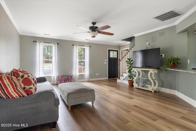 8 Saunders Ln, Pinehurst, NC 28374 - living area with stairs, wood finished floors, a ceiling fan, baseboards, and crown molding