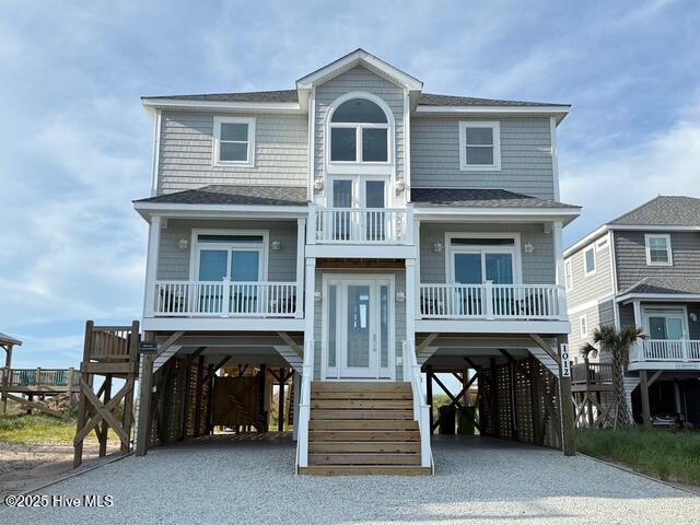 1012 New River Inlet Rd, North Topsail Beach, NC 28460 - raised beach house featuring a carport, driveway, and a balcony