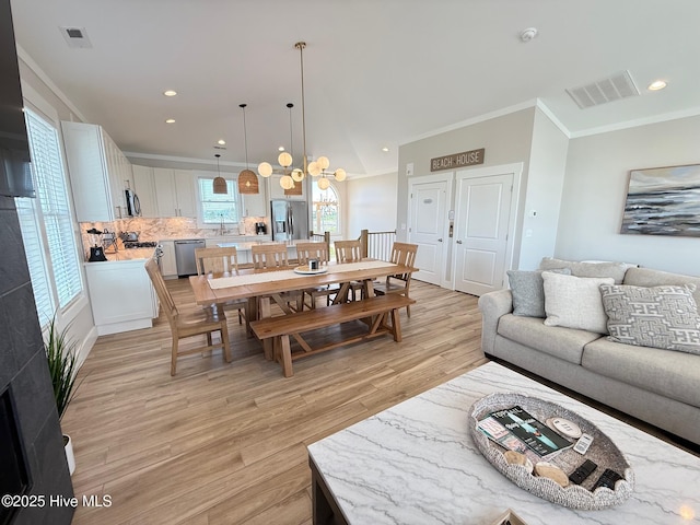 1012 New River Inlet Rd, North Topsail Beach, NC 28460 - living area with light wood-style flooring, ornamental molding, a chandelier, and recessed lighting
