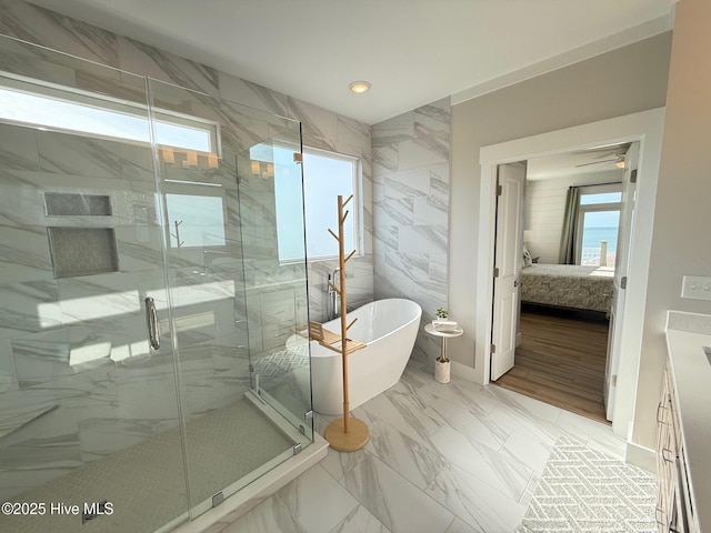 1012 New River Inlet Rd, North Topsail Beach, NC 28460 - ensuite bathroom featuring a soaking tub, marble finish flooring, a marble finish shower, recessed lighting, and vanity