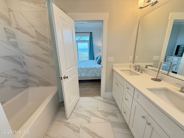 1012 New River Inlet Rd, North Topsail Beach, NC 28460 - ensuite bathroom featuring marble look tiles, double vanity, baseboards, and  shower combination