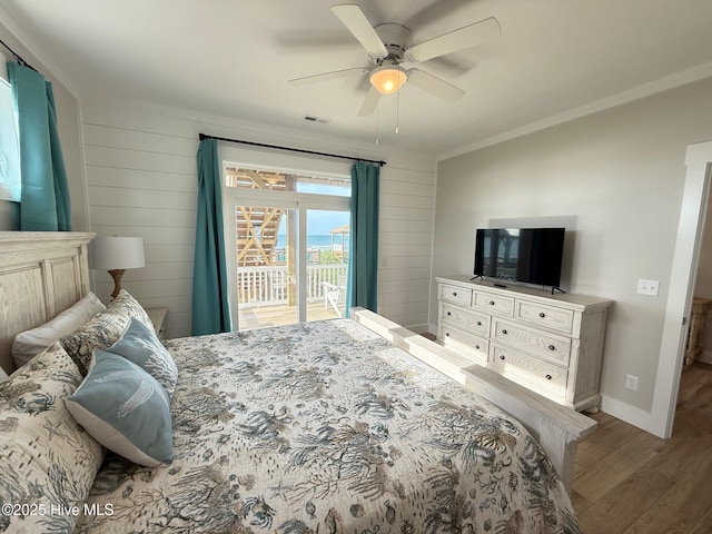 1012 New River Inlet Rd, North Topsail Beach, NC 28460 - bedroom with wood finished floors, access to exterior, baseboards, a ceiling fan, and crown molding