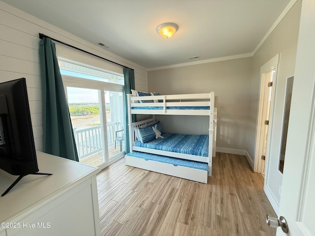 1012 New River Inlet Rd, North Topsail Beach, NC 28460 - unfurnished bedroom with ornamental molding, light wood-style flooring, access to exterior, and baseboards
