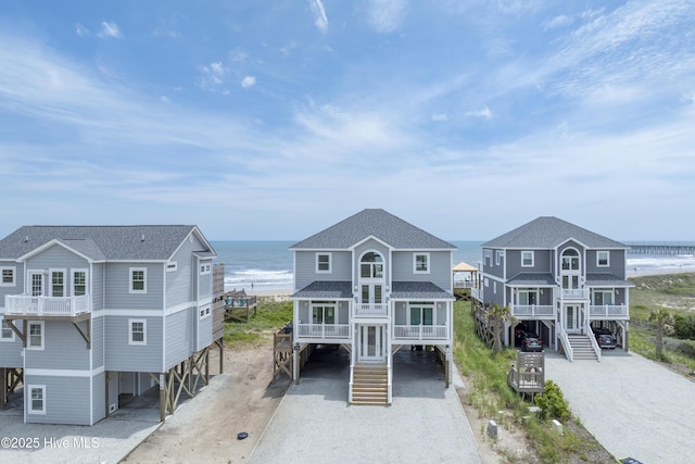 1012 New River Inlet Rd, North Topsail Beach, NC 28460 - beach home featuring a carport, stairway, view of water and beach, and driveway