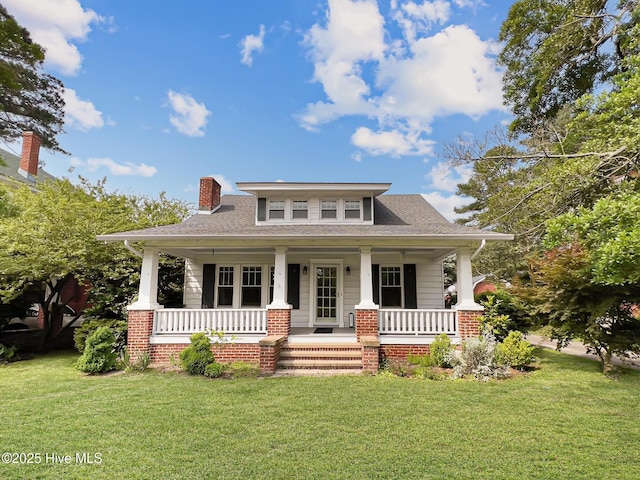 110 Virginia Rd, Edenton, NC 27932 - view of front of property with covered porch, a chimney, and a front yard