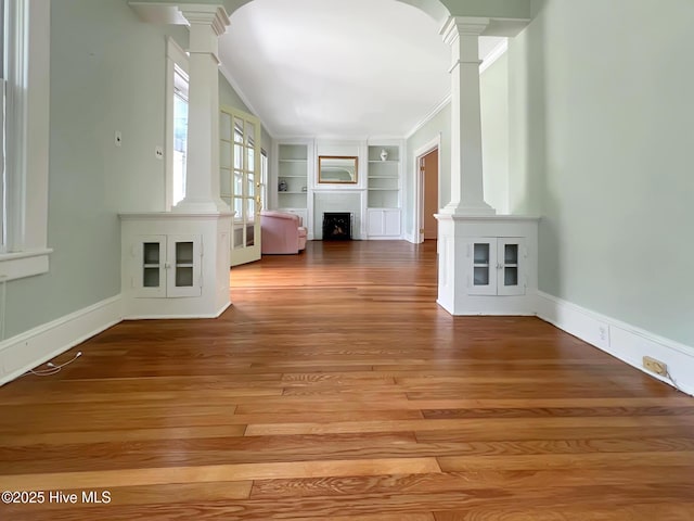 110 Virginia Rd, Edenton, NC 27932 - unfurnished living room with ornate columns, built in features, light wood finished floors, and a fireplace