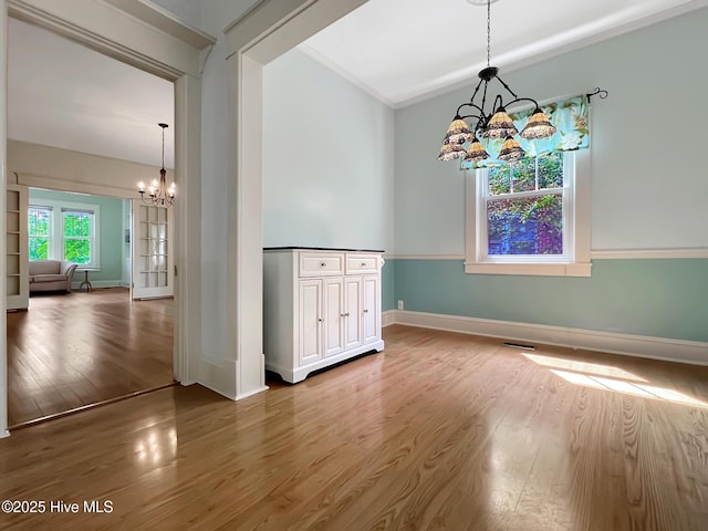 110 Virginia Rd, Edenton, NC 27932 - unfurnished dining area featuring a chandelier, baseboards, wood finished floors, and ornamental molding