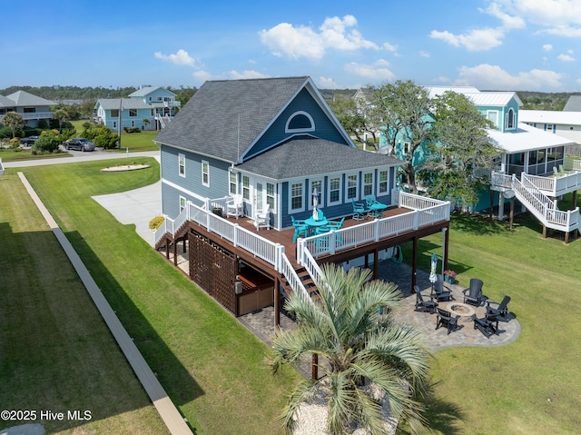 299 Waterway Dr, Sneads Ferry, NC 28460 - rear view of property featuring an outdoor fire pit, a shingled roof, a deck, stairway, and a patio