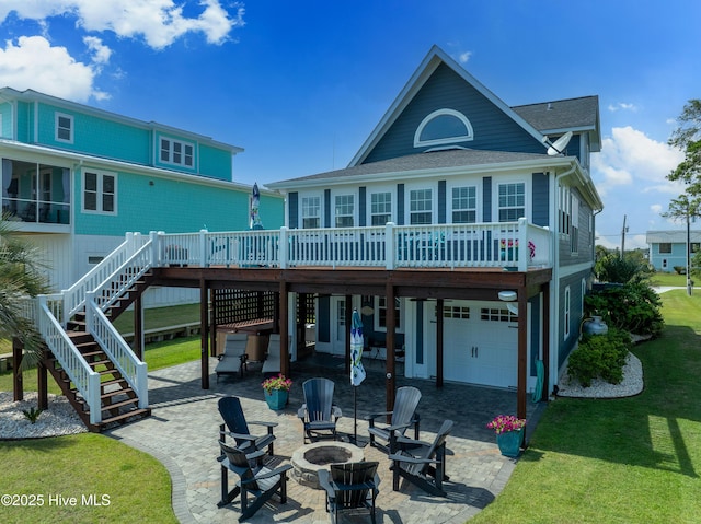 299 Waterway Dr, Sneads Ferry, NC 28460 - back of house featuring a fire pit, a garage, a wooden deck, and a patio