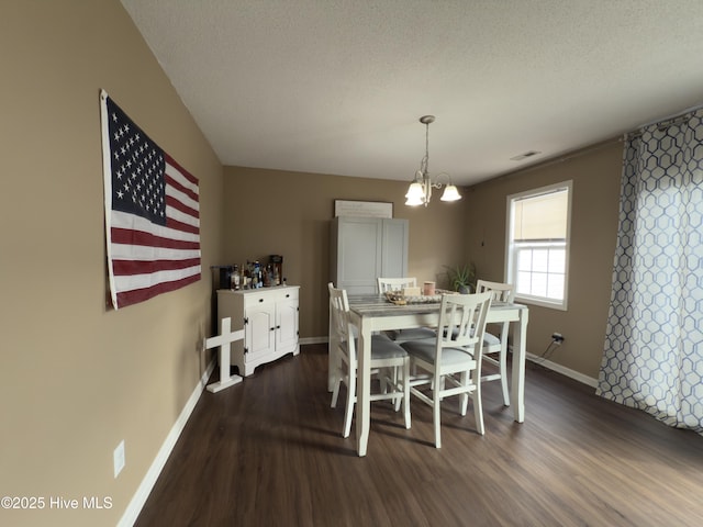 141 Jessie Cir, Hubert, NC 28539 - dining space with dark wood-style floors, a chandelier, and a textured ceiling