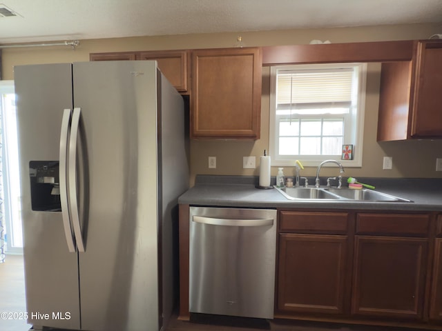 141 Jessie Cir, Hubert, NC 28539 - kitchen with appliances with stainless steel finishes, dark countertops, and brown cabinetry