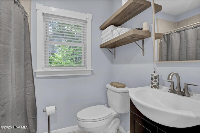 323 Cape Fear Blvd, Wilmington, NC 28401 - bathroom featuring toilet, vanity, baseboards, and curtained shower