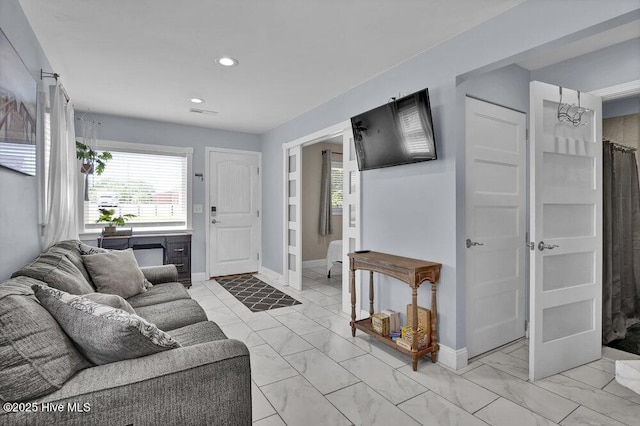 323 Cape Fear Blvd, Wilmington, NC 28401 - living room featuring light marble finish floors, recessed lighting, healthy amount of natural light, and baseboards