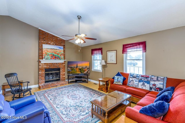 4909 Creekside Dr, New Bern, NC 28562 - living room featuring wood finished floors, vaulted ceiling, a ceiling fan, a brick fireplace, and baseboards