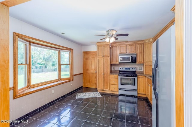 4909 Creekside Dr, New Bern, NC 28562 - kitchen with stainless steel appliances, dark tile patterned floors, baseboards, ceiling fan, and tasteful backsplash