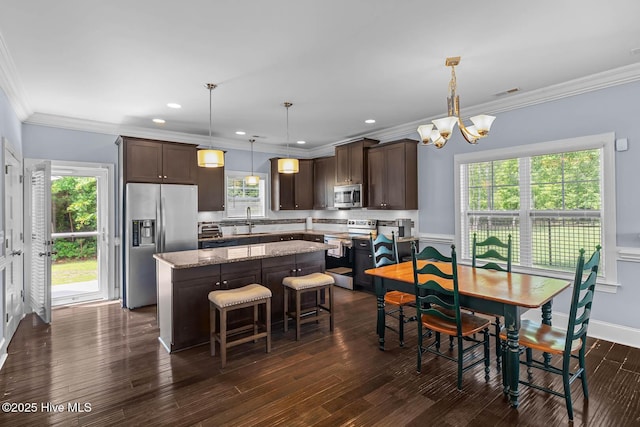 266 Marsh Haven Dr, Sneads Ferry, NC 28460 - kitchen featuring appliances with stainless steel finishes, dark brown cabinetry, a kitchen island, a chandelier, and a sink