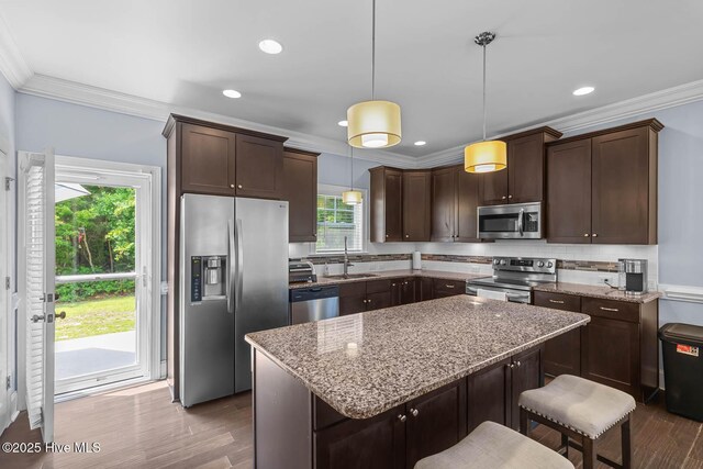 266 Marsh Haven Dr, Sneads Ferry, NC 28460 - kitchen featuring stainless steel appliances, a sink, crown molding, dark wood-style flooring, and dark brown cabinets