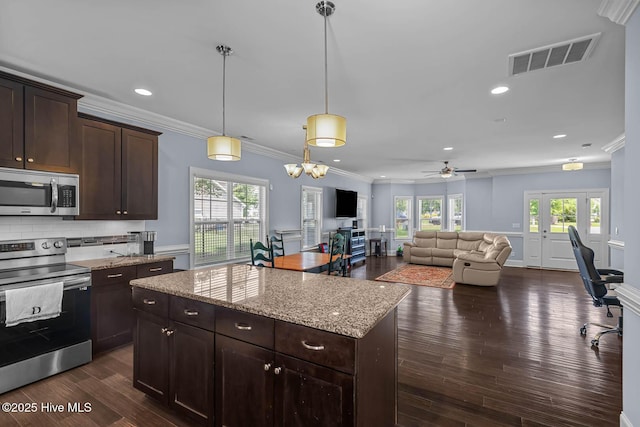266 Marsh Haven Dr, Sneads Ferry, NC 28460 - kitchen with appliances with stainless steel finishes, ornamental molding, healthy amount of natural light, dark brown cabinets, and open floor plan