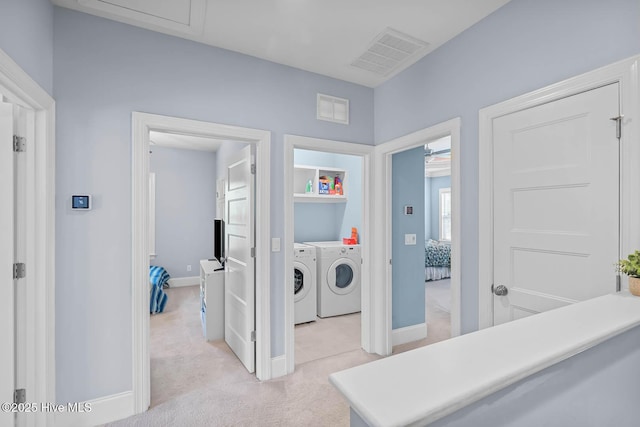266 Marsh Haven Dr, Sneads Ferry, NC 28460 - hall with washing machine and clothes dryer, light colored carpet, and baseboards