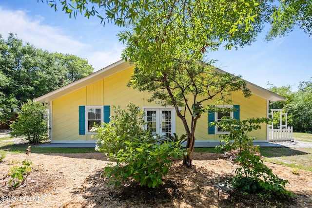 120 NW 19th St, Oak Island, NC 28465 - rear view of property featuring french doors