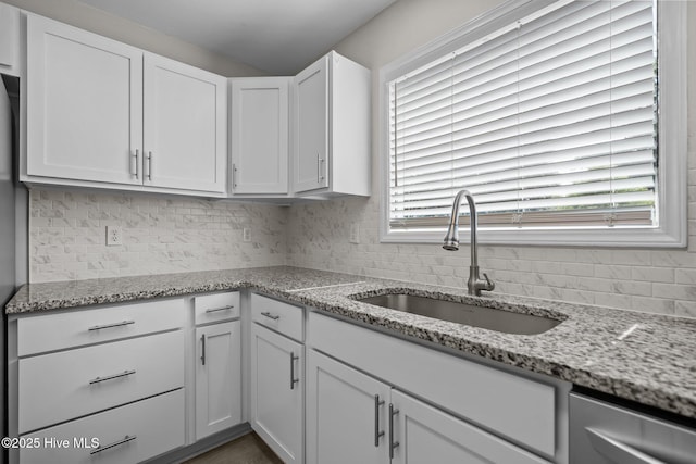 120 NW 19th St, Oak Island, NC 28465 - kitchen featuring a sink, white cabinets, decorative backsplash, and dishwasher