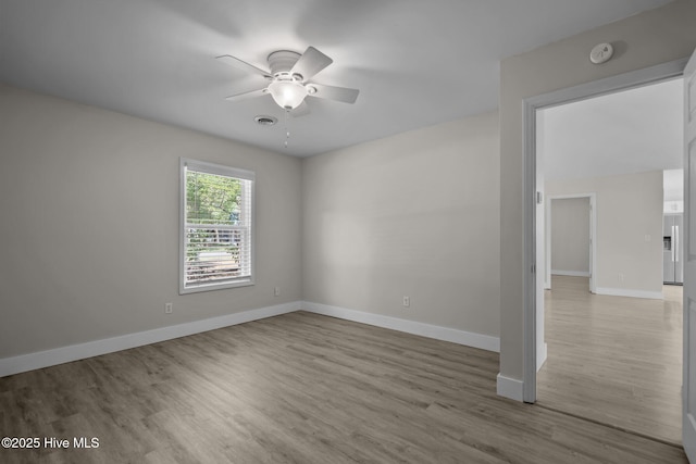 120 NW 19th St, Oak Island, NC 28465 - unfurnished room with a ceiling fan, wood finished floors, a smoke detector, and baseboards