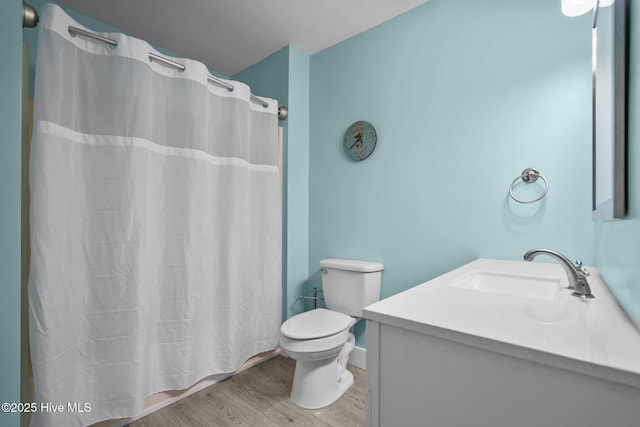 120 NW 19th St, Oak Island, NC 28465 - full bathroom featuring toilet, vanity, wood finished floors, and curtained shower