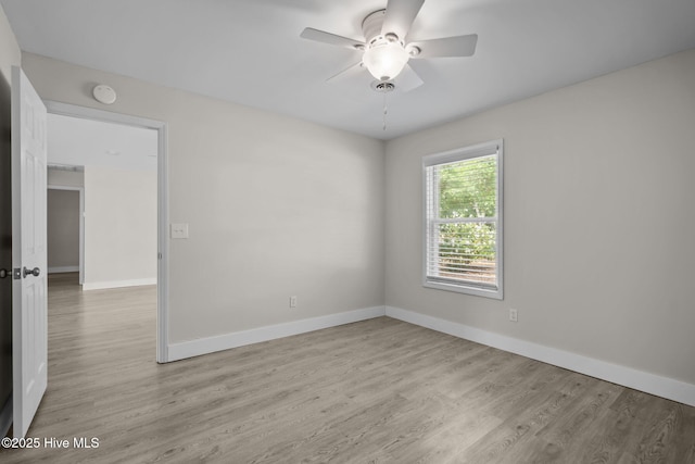 120 NW 19th St, Oak Island, NC 28465 - spare room featuring light wood-type flooring, ceiling fan, baseboards, and a smoke detector