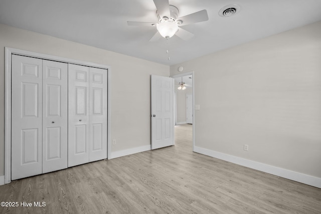 120 NW 19th St, Oak Island, NC 28465 - unfurnished bedroom featuring baseboards, wood finished floors, a closet, and ceiling fan