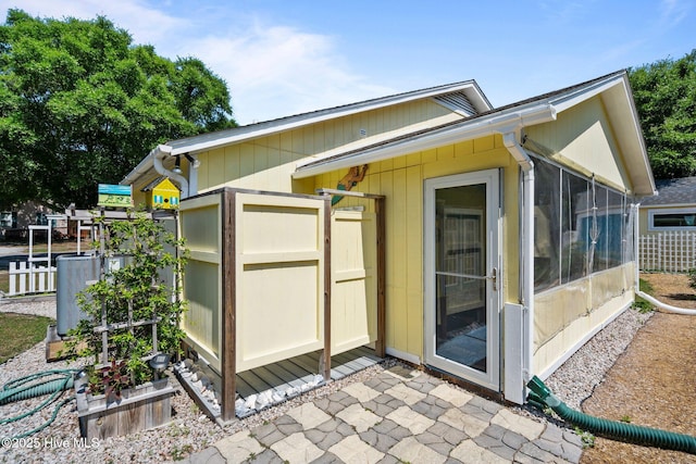 120 NW 19th St, Oak Island, NC 28465 - view of home's exterior with a sunroom