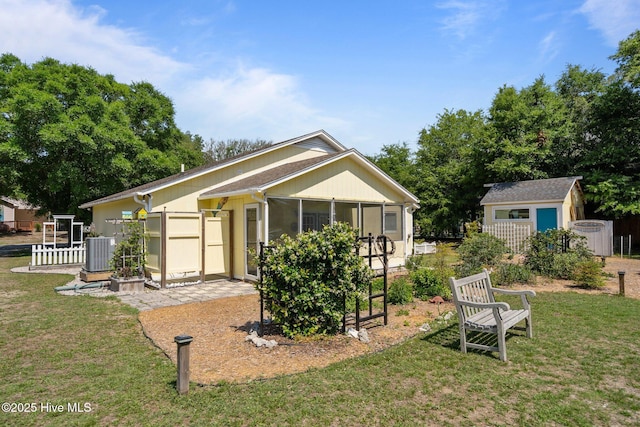 120 NW 19th St, Oak Island, NC 28465 - back of property featuring a sunroom, a yard, and cooling unit