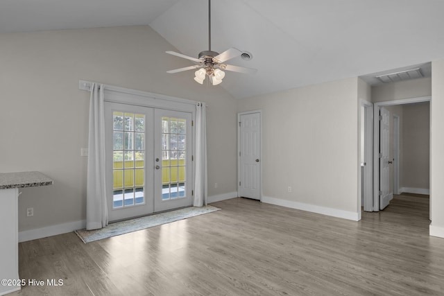 120 NW 19th St, Oak Island, NC 28465 - unfurnished room with french doors, ceiling fan, lofted ceiling, wood finished floors, and baseboards