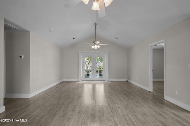 120 NW 19th St, Oak Island, NC 28465 - unfurnished living room featuring ceiling fan, wood finished floors, lofted ceiling, baseboards, and french doors