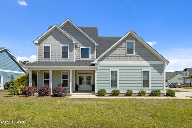 601 Trawler Pl, Newport, NC 28570 - view of front facade with a front lawn, french doors, covered porch, and roof with shingles