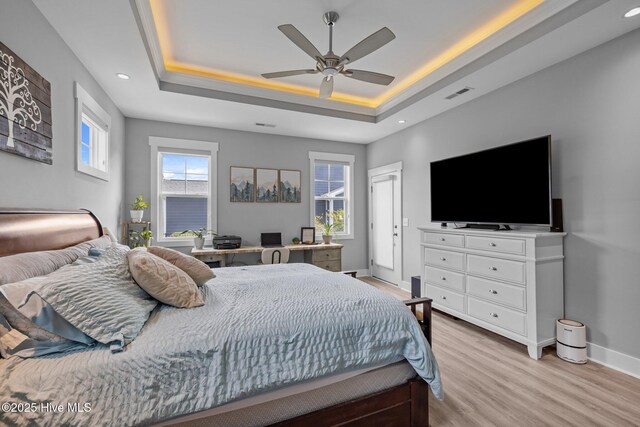 601 Trawler Pl, Newport, NC 28570 - bedroom featuring light wood-style floors, a tray ceiling, baseboards, recessed lighting, and ceiling fan