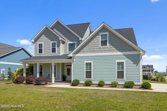 601 Trawler Pl, Newport, NC 28570 - view of front of house featuring a porch, a front yard, and roof with shingles