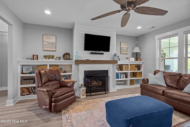 601 Trawler Pl, Newport, NC 28570 - living area featuring a ceiling fan, wood finished floors, baseboards, a fireplace, and recessed lighting