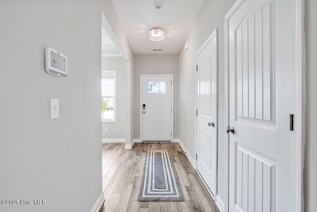 2610 Longleaf Pine Cir, Leland, NC 28451 - doorway with baseboards and light wood finished floors
