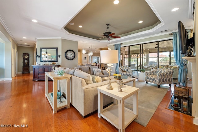 2215 Villamar Dr, Leland, NC 28451 - living area featuring a ceiling fan, ornamental molding, a tray ceiling, recessed lighting, and wood finished floors