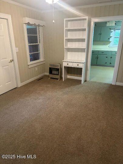 302 N Main St, Robersonville, NC 27871 - unfurnished living room featuring heating unit, crown molding, and carpet