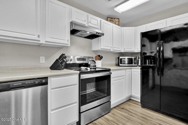 7475 Thais Trl, Wilmington, NC 28411 - kitchen featuring stainless steel appliances, under cabinet range hood, white cabinets, light countertops, and light wood-style floors