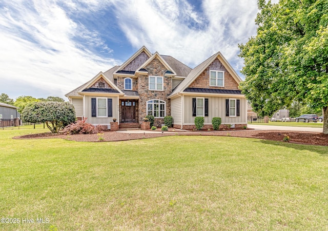 craftsman house featuring board and batten siding, a front yard, and a standing seam roof