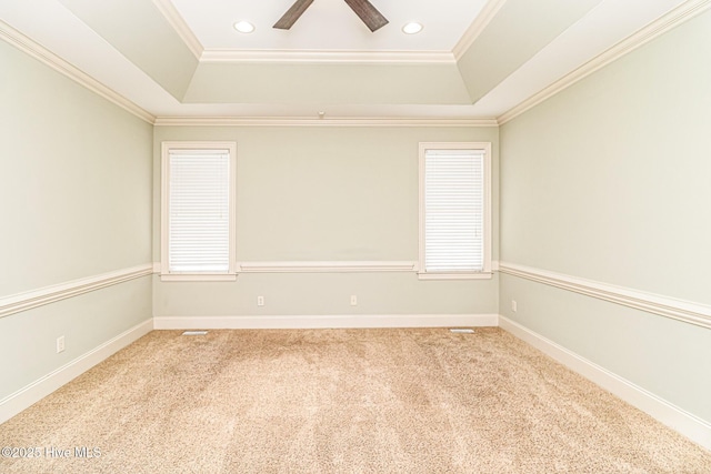 carpeted spare room featuring a tray ceiling, crown molding, a ceiling fan, recessed lighting, and baseboards