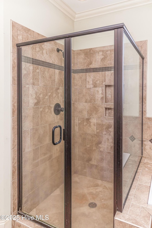 full bathroom featuring ornamental molding and a stall shower