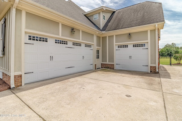garage with driveway and fence