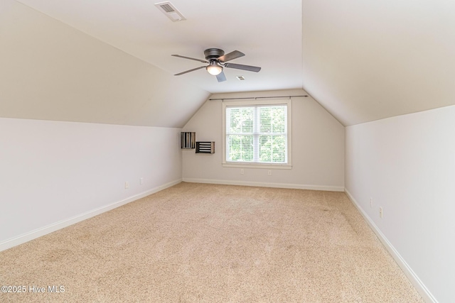 additional living space featuring lofted ceiling, carpet, baseboards, and a ceiling fan