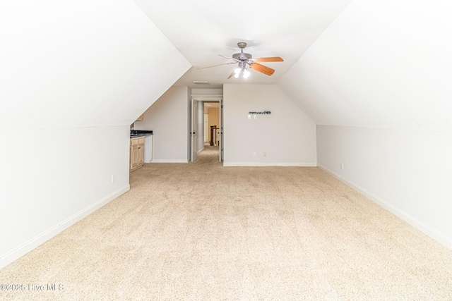 bonus room with light carpet, lofted ceiling, baseboards, and ceiling fan