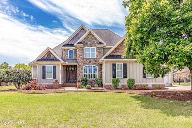 craftsman-style home with board and batten siding, a front lawn, stone siding, and a shingled roof