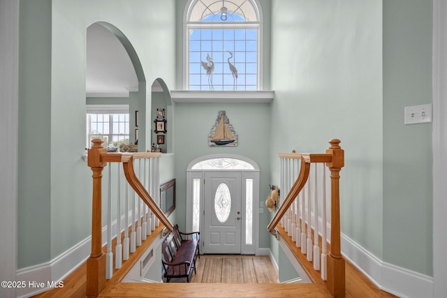 208 Sea Manor Dr, Surf City, NC 28445 - entryway featuring a towering ceiling, wood finished floors, arched walkways, and baseboards